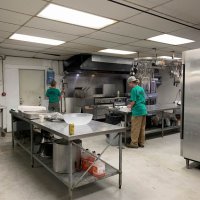 Logan and Kristi cleaning the kitchen