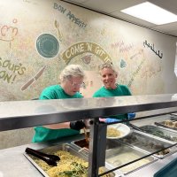 Margo and Kristi serving dinner